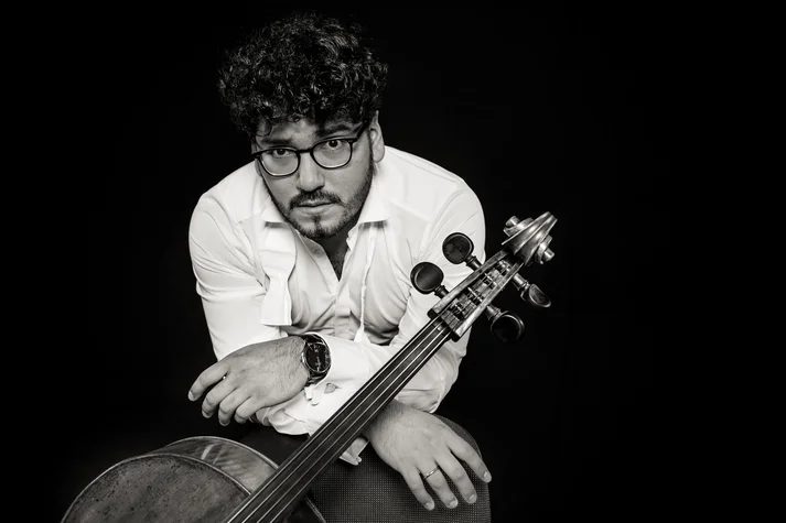 Cellist Alexandre Castro-Balbi in schwarz-weiß mit Instrument
